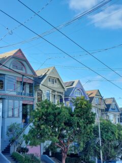 Picture of a road in San Francisco with victorian-style houses in bright colours